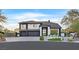 Striking two-story home featuring a modern design, well-manicured landscaping, and a three-car garage at 8717 Kingship Ct, Las Vegas, NV 89129