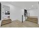 Upstairs landing with wooden floors and black framed glass railings at 8717 Kingship Ct, Las Vegas, NV 89129