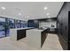 Open floor plan kitchen with bright countertops, modern appliances, and pool view at 8717 Kingship Ct, Las Vegas, NV 89129