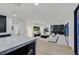 Open-concept living room with sleek modern design and access to outdoor living at 8717 Kingship Ct, Las Vegas, NV 89129