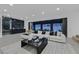 Bright living room with view to the backyard, white sofa, and black marble accent wall at 8717 Kingship Ct, Las Vegas, NV 89129