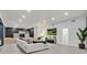 Open-concept living area with kitchen, white couch, and recessed lighting at 8717 Kingship Ct, Las Vegas, NV 89129