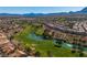 Scenic aerial view overlooking the community golf course, landscaping, and mountain views at 8812 Stoney Point Dr, Las Vegas, NV 89134