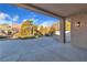 Covered patio featuring a concrete floor, lighting and views of drought resistant landscaping and mature trees at 8812 Stoney Point Dr, Las Vegas, NV 89134