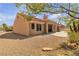Charming backyard with mature landscaping, including a covered patio for outdoor lounging and a neutral colored exterior at 8812 Stoney Point Dr, Las Vegas, NV 89134