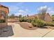 Backyard featuring drought resistant landscaping, mature trees, green shrubs, rock features, and a walkway around the home at 8812 Stoney Point Dr, Las Vegas, NV 89134