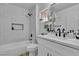 Bright bathroom featuring a shower-over-tub setup and a white vanity with marble countertop at 8812 Stoney Point Dr, Las Vegas, NV 89134