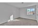 Bright bedroom featuring neutral carpet, white walls, and a sunny window at 8812 Stoney Point Dr, Las Vegas, NV 89134