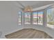 Cozy dining area with natural lighting, wood-look flooring, and views of the lush greenery outdoors at 8812 Stoney Point Dr, Las Vegas, NV 89134