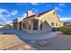 The exterior of this home showcases beautiful neutral toned stucco, mature landscaping, and a red tile roof at 8812 Stoney Point Dr, Las Vegas, NV 89134