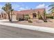 Beautiful single-story home featuring desert landscaping, a red tile roof, and a two-car garage at 8812 Stoney Point Dr, Las Vegas, NV 89134