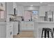 Bright kitchen features a waterfall island, stainless steel appliances, and wood flooring at 8812 Stoney Point Dr, Las Vegas, NV 89134