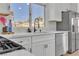 Bright kitchen showcases an island, modern appliances, and white cabinets at 8812 Stoney Point Dr, Las Vegas, NV 89134