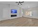 Bright living room with a fireplace, TV, and large windows offering natural light at 8812 Stoney Point Dr, Las Vegas, NV 89134