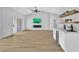 Open living area with wood floors, a fireplace, and a built-in bar at 8812 Stoney Point Dr, Las Vegas, NV 89134