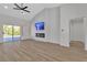 Bright living room with a fireplace, TV, and a sliding glass door offering outdoor access at 8812 Stoney Point Dr, Las Vegas, NV 89134