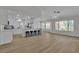 Open concept living space with modern kitchen island, hardwood flooring, and lots of natural light at 8812 Stoney Point Dr, Las Vegas, NV 89134