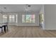 Bright living room with hardwood flooring, large windows, and contemporary lighting fixtures at 8812 Stoney Point Dr, Las Vegas, NV 89134