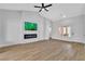 Open living area with wood floors, a fireplace, and modern ceiling fan at 8812 Stoney Point Dr, Las Vegas, NV 89134
