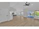 Expansive living room with open layout, modern kitchen, and sliding glass doors to the backyard at 8812 Stoney Point Dr, Las Vegas, NV 89134