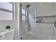 Tiled shower with glass door and organized shelving at 8812 Stoney Point Dr, Las Vegas, NV 89134