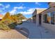 Nicely landscaped side yard with drought-resistant vegetation, hardscape, and views of the covered outdoor space at 8812 Stoney Point Dr, Las Vegas, NV 89134