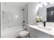 Modern bathroom showcasing marble-tiled shower, sleek black fixtures, and white vanity at 887 W Carey Ave, North Las Vegas, NV 89030