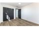 Bedroom featuring wood flooring and closet with dark double doors at 887 W Carey Ave, North Las Vegas, NV 89030