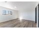 Bright bedroom featuring wood flooring, neutral walls, and a sun-filled window at 887 W Carey Ave, North Las Vegas, NV 89030