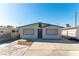 Charming single story home featuring a modern exterior and well maintained landscaping with a large driveway at 887 W Carey Ave, North Las Vegas, NV 89030