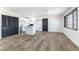 Bright kitchen boasts white cabinets, stainless steel appliances, a center island, and wood-look floors at 887 W Carey Ave, North Las Vegas, NV 89030