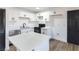 Modern kitchen featuring white cabinets, stainless steel appliances, a center island, and wood-look floors at 887 W Carey Ave, North Las Vegas, NV 89030