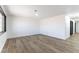 Spacious living room with recessed lighting, wood-look floors, and freshly painted white walls at 887 W Carey Ave, North Las Vegas, NV 89030