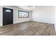 Bright living room featuring wood-look floors, large windows, and a modern front door at 887 W Carey Ave, North Las Vegas, NV 89030