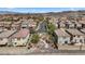 An aerial view of a residential neighborhood featuring similar homes, desert landscaping, and mountain views at 922 Harbor Ave, Henderson, NV 89002