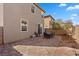 Spacious backyard featuring a brick paver patio, ideal for outdoor dining and relaxing, with view of house exterior at 922 Harbor Ave, Henderson, NV 89002