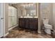 Modern bathroom with a double sink vanity, a glass-enclosed shower, and stylish fixtures, providing a luxurious and functional space at 922 Harbor Ave, Henderson, NV 89002
