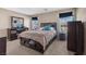 The spacious bedroom has a large bed, dresser, nightstands, and soft carpet, providing a comfortable and stylish retreat at 922 Harbor Ave, Henderson, NV 89002