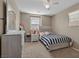Cozy bedroom with a comfortable bed, dresser, and ample natural light, creating a relaxing and inviting space at 922 Harbor Ave, Henderson, NV 89002