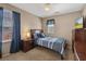 Cozy bedroom with neutral walls, ceiling fan, and a single bed with striped bedding at 922 Harbor Ave, Henderson, NV 89002