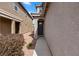 Side view of a charming home entrance featuring a dark front door and desert landscaping at 922 Harbor Ave, Henderson, NV 89002