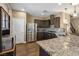 Spacious kitchen with stainless steel appliances, granite countertops, dark cabinets, and modern fixtures at 922 Harbor Ave, Henderson, NV 89002