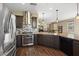 Well-equipped kitchen with stainless steel appliances, stylish backsplash, granite counters, and dark cabinets at 922 Harbor Ave, Henderson, NV 89002