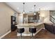 Modern kitchen features granite countertops, stainless steel appliances, a breakfast bar, and dark wood cabinetry at 922 Harbor Ave, Henderson, NV 89002