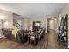 Inviting living room features a staircase, wood flooring, and modern decor, bathed in natural light at 922 Harbor Ave, Henderson, NV 89002