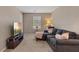 Comfortable living room featuring a gray sectional sofa, TV, and plush accents at 922 Harbor Ave, Henderson, NV 89002