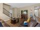 Comfortable living room boasts warm wood floors, a decorative staircase, and a wall-mounted television at 922 Harbor Ave, Henderson, NV 89002