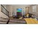 Inviting living room featuring hardwood floors, a comfortable leather couch, and a decorative fireplace with a flat screen TV at 922 Harbor Ave, Henderson, NV 89002