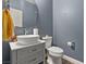 Modern powder room featuring a vessel sink, gray cabinets, and a toilet at 922 Harbor Ave, Henderson, NV 89002