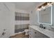 Well-lit bathroom featuring a marble countertop, vanity, and modern mirror at 10001 Peace Way # 1321, Las Vegas, NV 89147